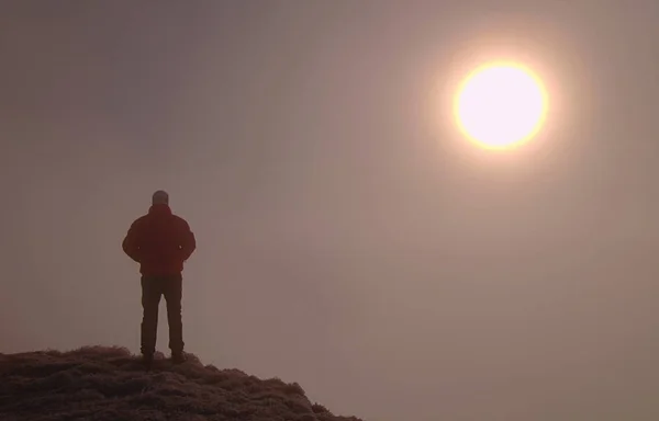 Man alone on summit. Man enjoy standing above noisy world
