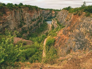 Derin büyük kanyon, dibinde mavi göl var. Birçok yol 