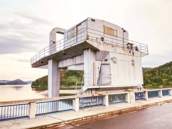 Crane for control water gate on dam. Crumbling dam across the river — Stock Photo, Image