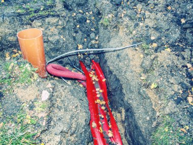 Kırmızı nervürlü koruyucu boru içinde çelik kablo ile.