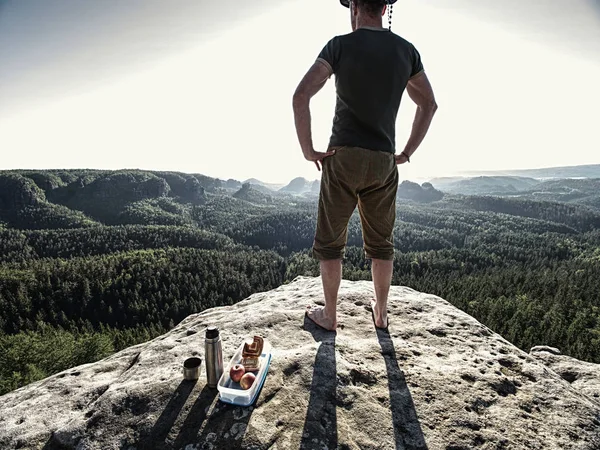 Handsome man took rest for snack. Tourist stay on summit rock — Stock Photo, Image