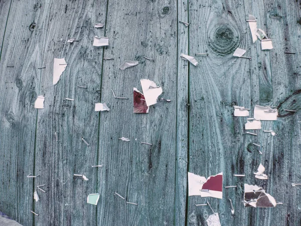Scraps of paper on a wooden wall or  old wooden fence.