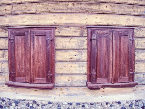 Outdoor view of part of ancient closed wooden shutters. — Stock Photo, Image