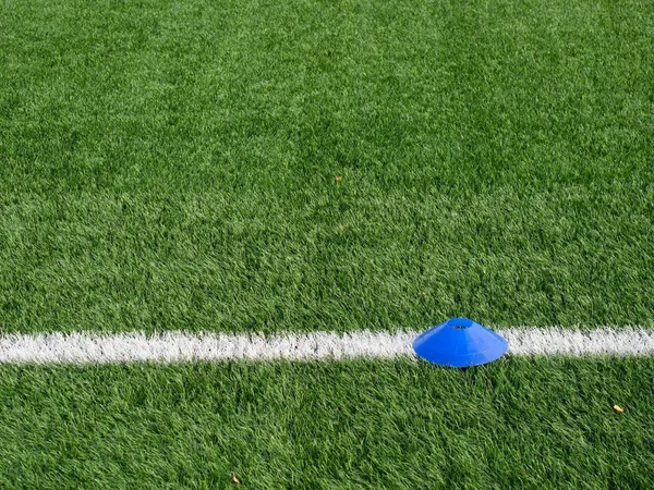 Cones are soccer training equipment on green artificial turf — Stock Photo, Image