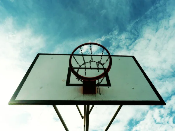 Urban Basketball hoop at sunset with skyline — Stock Photo, Image