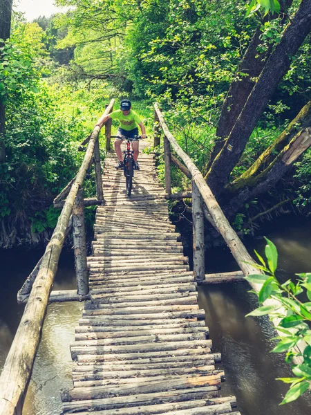 Small Fearless Biker Crossing Wooden Bridge Pine Logs Muddy Stream — Stock Photo, Image