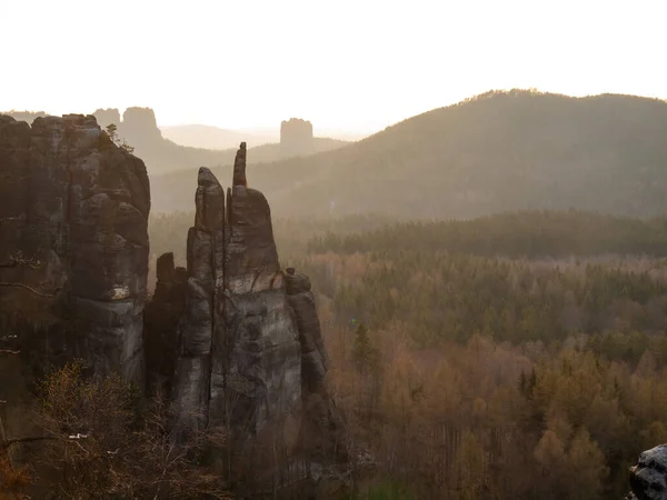 Rocky columns at Blosstock rock and far Falkenstein seen from Affensteine  viewing point in Saxony Switzerland