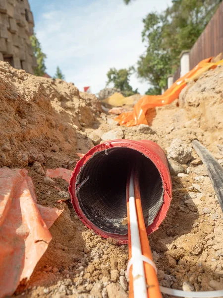 Data fiber optic cables in ribbed pipe under road. Wire in HDPE and protectivep tube. Building of lines of metallic and optic cables,