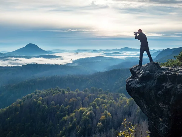 Hiker photographer framing picture with eye on viewfinder. Photographer  enthusiast enjoy work, fall nature.