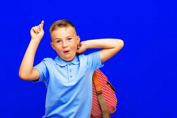 Возбужденный Маленький Школьник Рюкзаком Изолированным Синем Фоне Школа Дистанционного Образования — стоковое фото