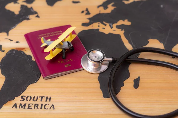 Stetoskop Pasaportlu Tıbbi Seyahat Konsepti Tahta Dünya Haritasında Oyuncak Uçak — Stok fotoğraf
