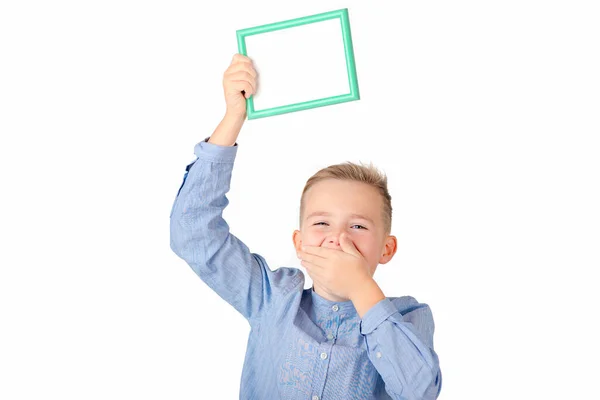 The mouth covered caucasian schoolboy in shirt posing on white studio isolated background. People lifestyle concept. Mock up copy space. Hold white empty blank billboard with place for text or image.