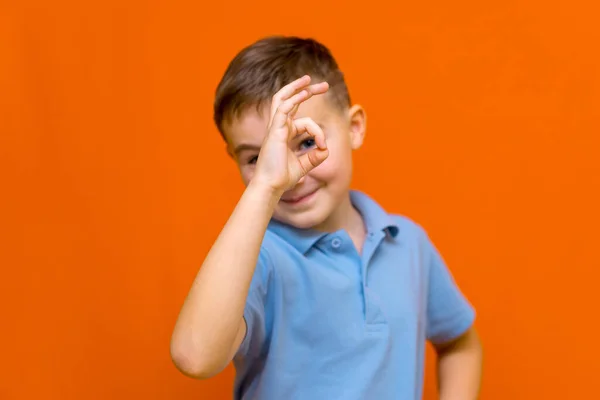 Portarait Caucasian Happy Smiling Little Boy Raised Hand Orange Studio — Stock Photo, Image