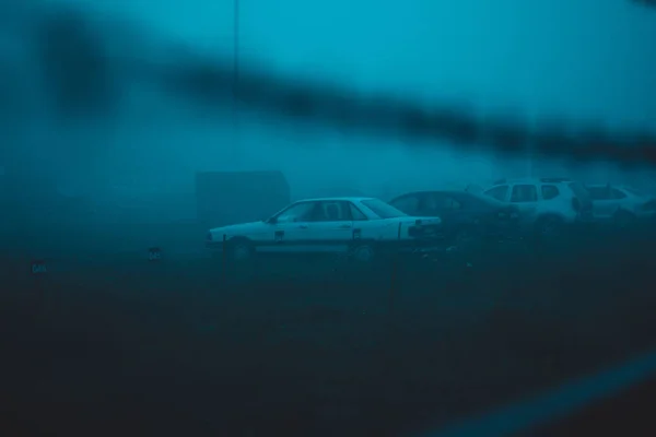 Old car parked in fog