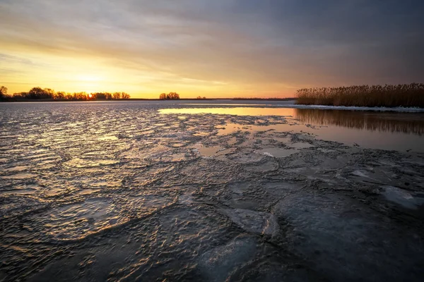美丽的冬季风景与冰冻的河面 芦苇和落日的天空 组成的性质 — 图库照片
