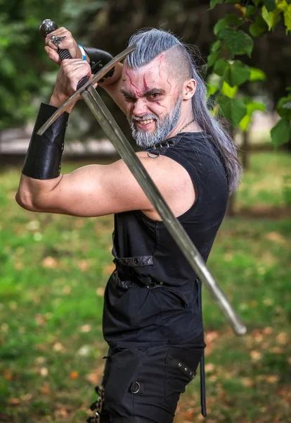 Personagem Cosplay, guerreiro forte com uma espada nas mãos. Um — Fotografia de Stock