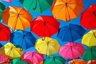 Colorful umbrellas in the sky as background. Street decoration. clipart