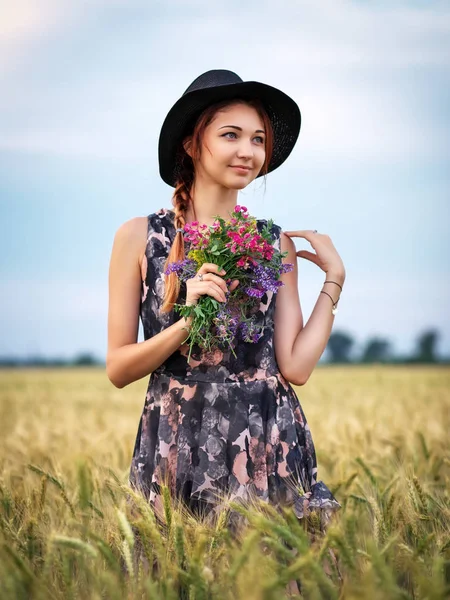 Linda chica atractiva con un ramo de flores de colores en su h —  Fotos de Stock