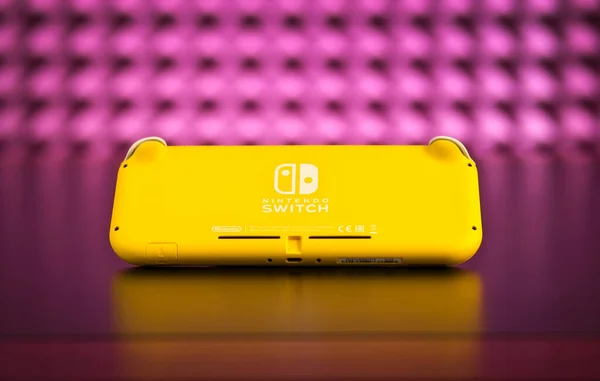 Nintendo Switch And Small Nintendo Switch Lite Comparison Of Two Handheld  Game Consoles Stock Photo - Download Image Now - iStock