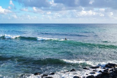 Gold Coast, Avustralya - Aralık, 2018: Okyanusta dalgaların yuvarlanmasını bekleyen bir sörfçünün güzel fotoğrafı.