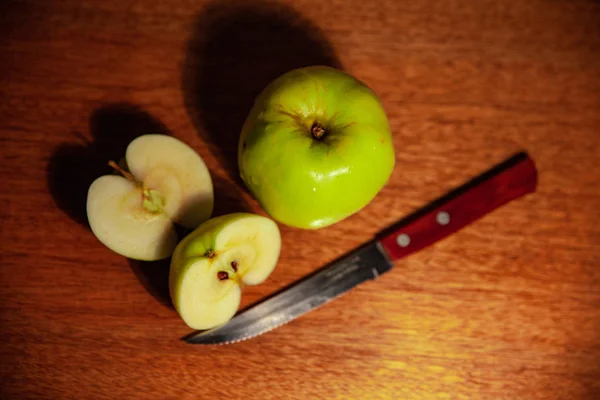 Dark green apple, food. Cut apple