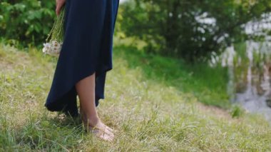 Nehrin kenarında duran yazlık elbiseli kadın.