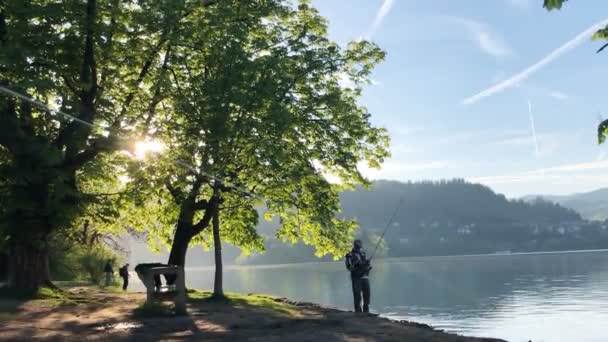 Män fångar fisk på sjön Bled i Slovenien — Stockvideo