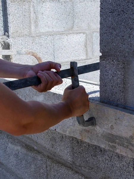 Male and female hands with building materials — Stock Photo, Image