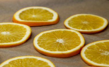 Kurutmak için dilimlenmiş taze portakal halkaları.