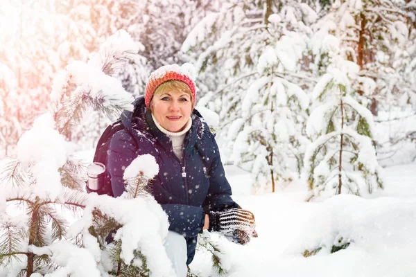 stock image Woman walking in winter forest. A middle-aged woman is freezing in the Park.