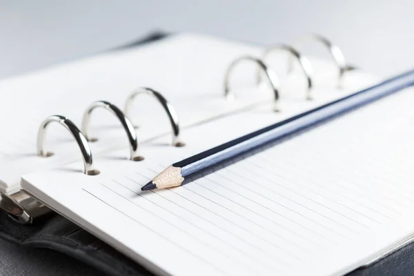 Kalem ve arkaplan tasarımı ile masada not defteri — Stok fotoğraf