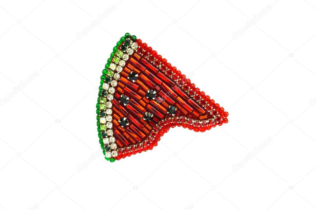 Brooch handmade made of multicolored beads on the background