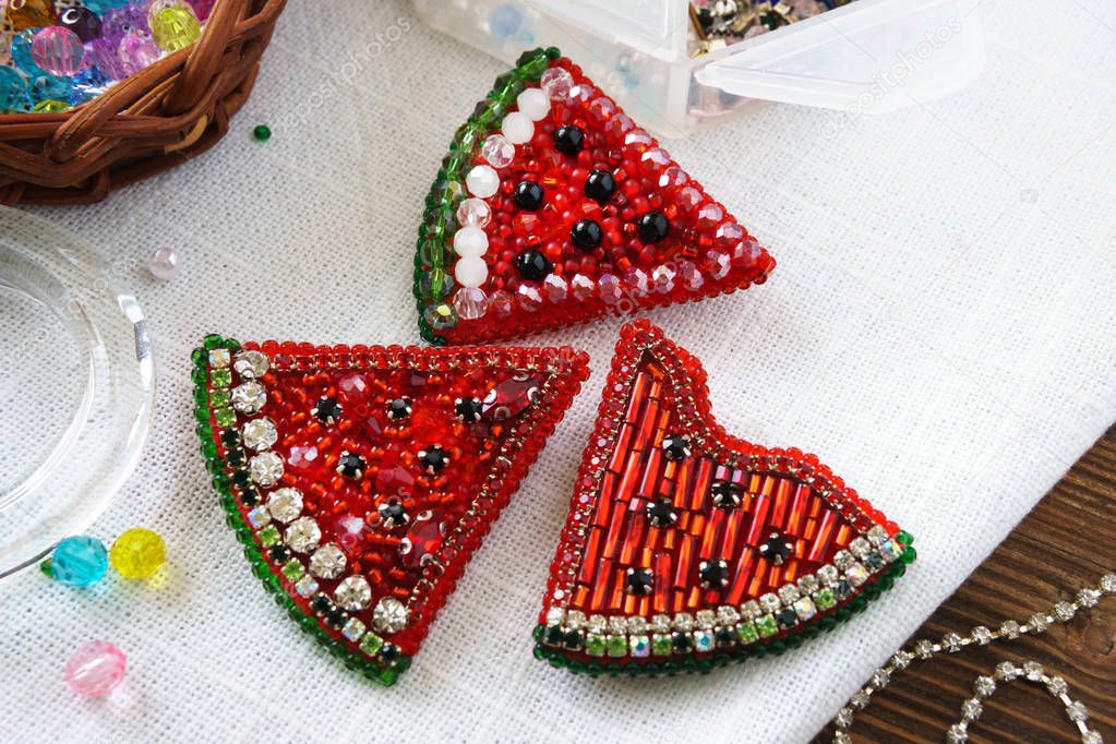 Brooch made of handmade colored beads on the background