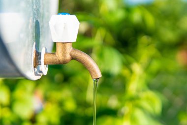 Su musluğu yerel bahçedeki büyük metal bir su tankına monte edilir.