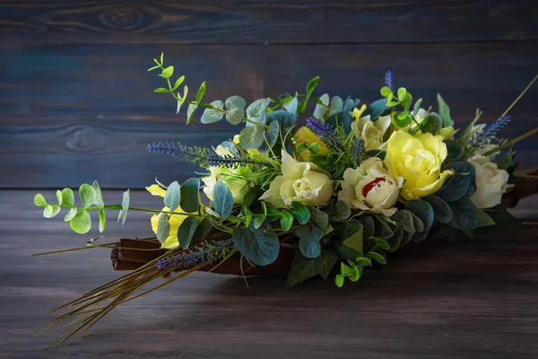 Flowers in a pot on a wooden background. Plants made of artificial materials made by a florist for design on wood background