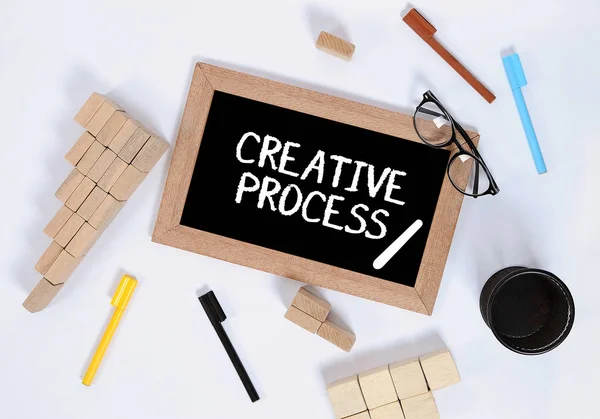 Top view of creative process / Creative process on blackboard wi