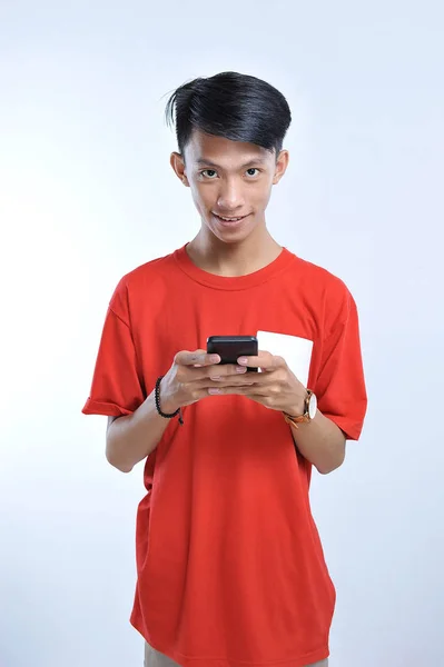 Potrait of young asian student playing a smartphone — Stok Foto