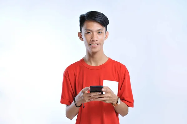 Potrait of young asian student playing a smartphone — Stok Foto