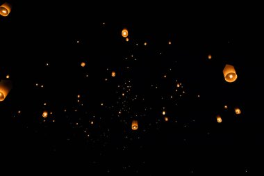 Loi Krathong and Yi Peng released paper lanterns on the sky during night clipart