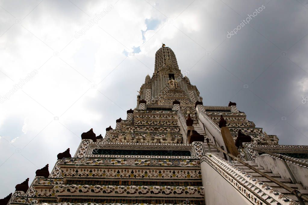 View from below of the Wat Arun temple at Bangkok with the sky in the background