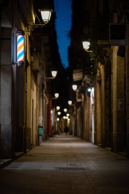 Blurred downtown alley at night with barbershop or hairdresser's clipart