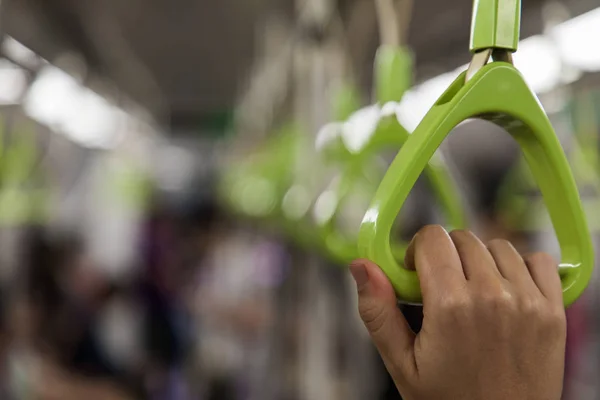 Close up of a woman hand grabbing a handle inside the metro of S — Stock Photo, Image