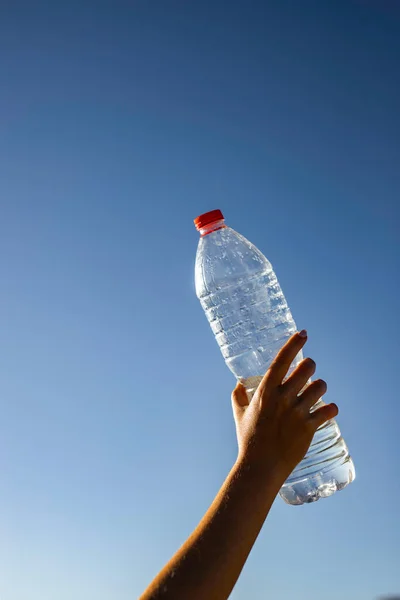 Woman Hand Holding Unlabeled Plastic Water Bottle Clear Blue Sky — Stock Photo, Image