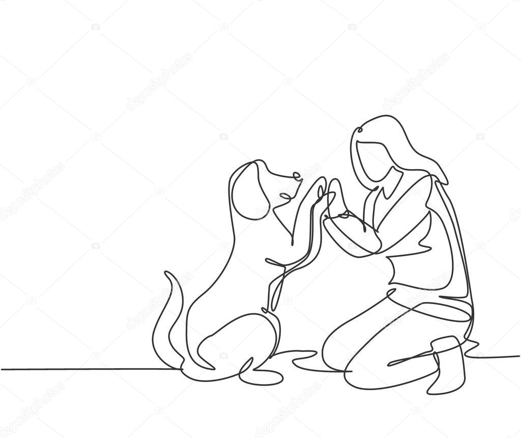 One line drawing of young happy woman squat then giving high five gesture to his dog at outfield park as friendship symbol. Pet care concept. Modern continuous line draw design vector illustration