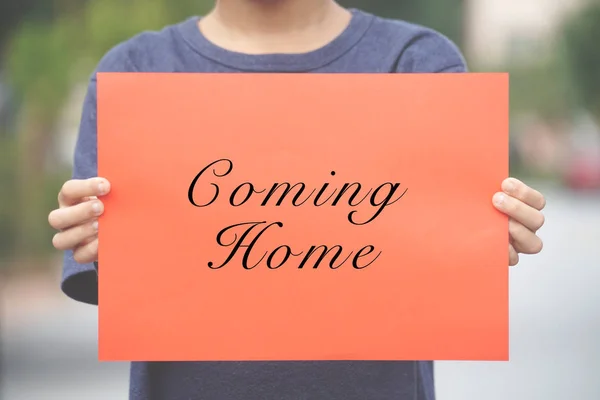 Boy Holding Placard Written Coming Home Greeting Words Vintage Editing — Stock Photo, Image