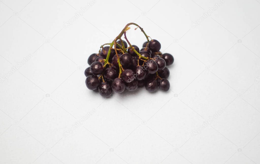 Bunch of ripe red grapes isolated on white background