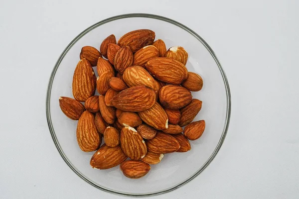 Heap Almond Nuts Glass Plate White Background — Stock Photo, Image