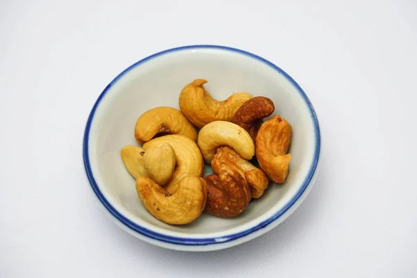 Pile Brown Cashew Nuts Little Bowl White Background — Stock Photo, Image