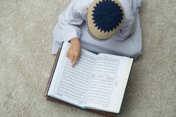 Вид Сверху Мальчика Читающего Книгу Корана Бежевом Ковре — стоковое фото