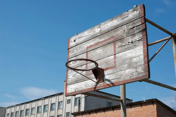 Old basketball ring on the sky background